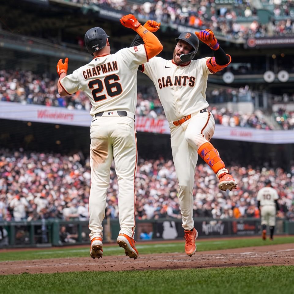 Giants players celebrating at home plate